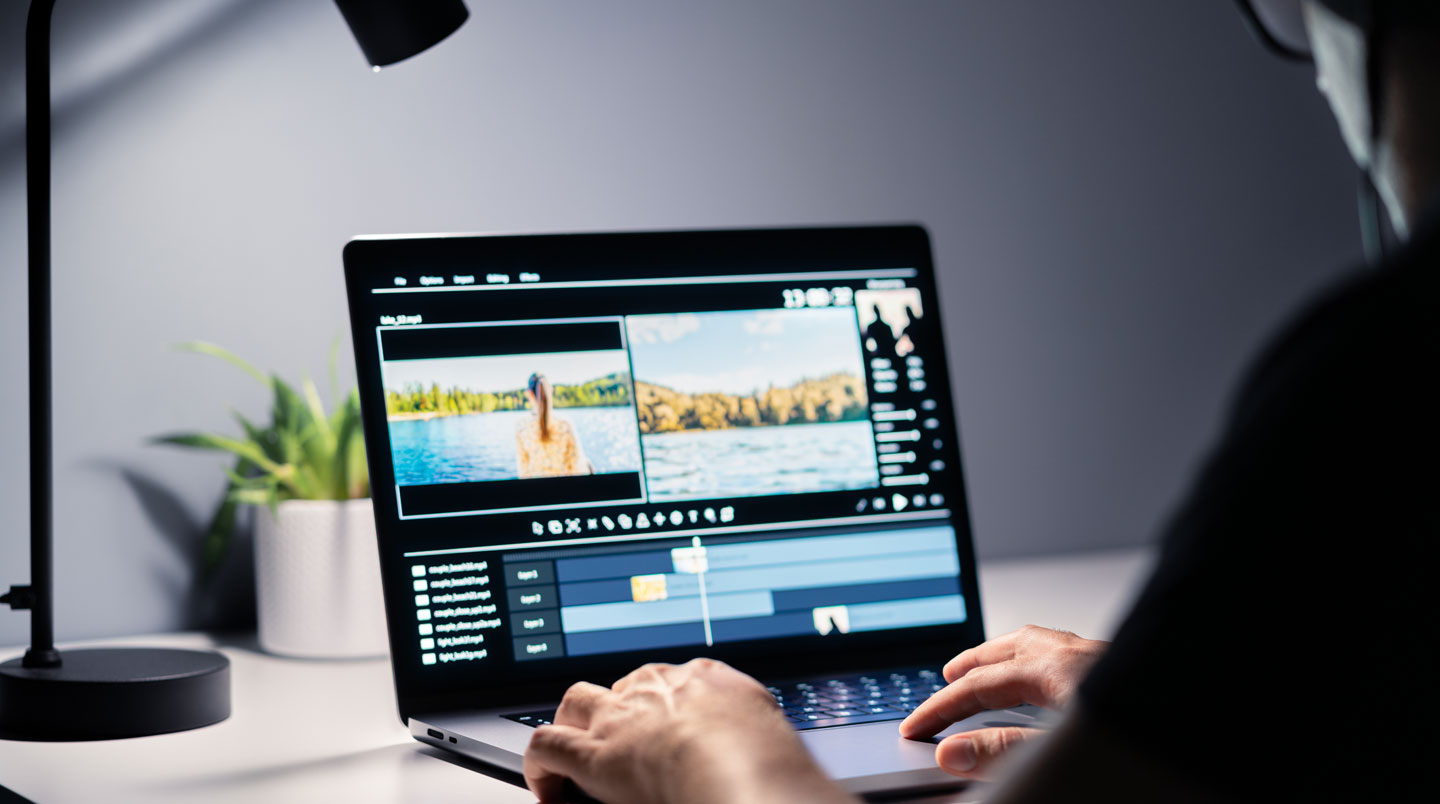 Marketing professional overwhelmed by complex video editing interface on multiple monitors