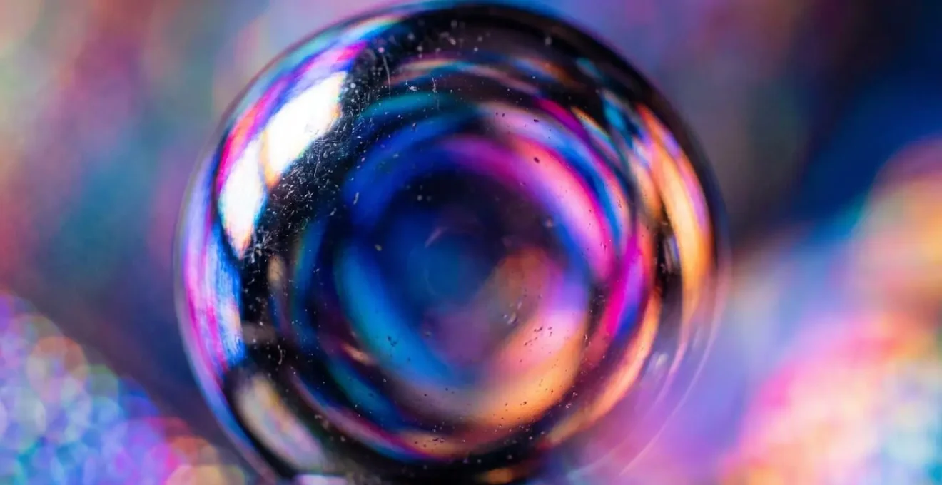 Macro shot of metallic surface reflecting colorful LED panel lights in a production environment
