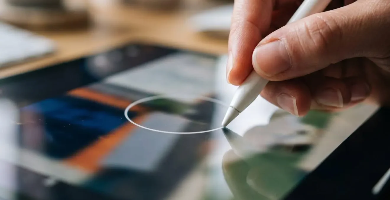 Close-up of a designer's hand drawing precise annotations on a video frame.